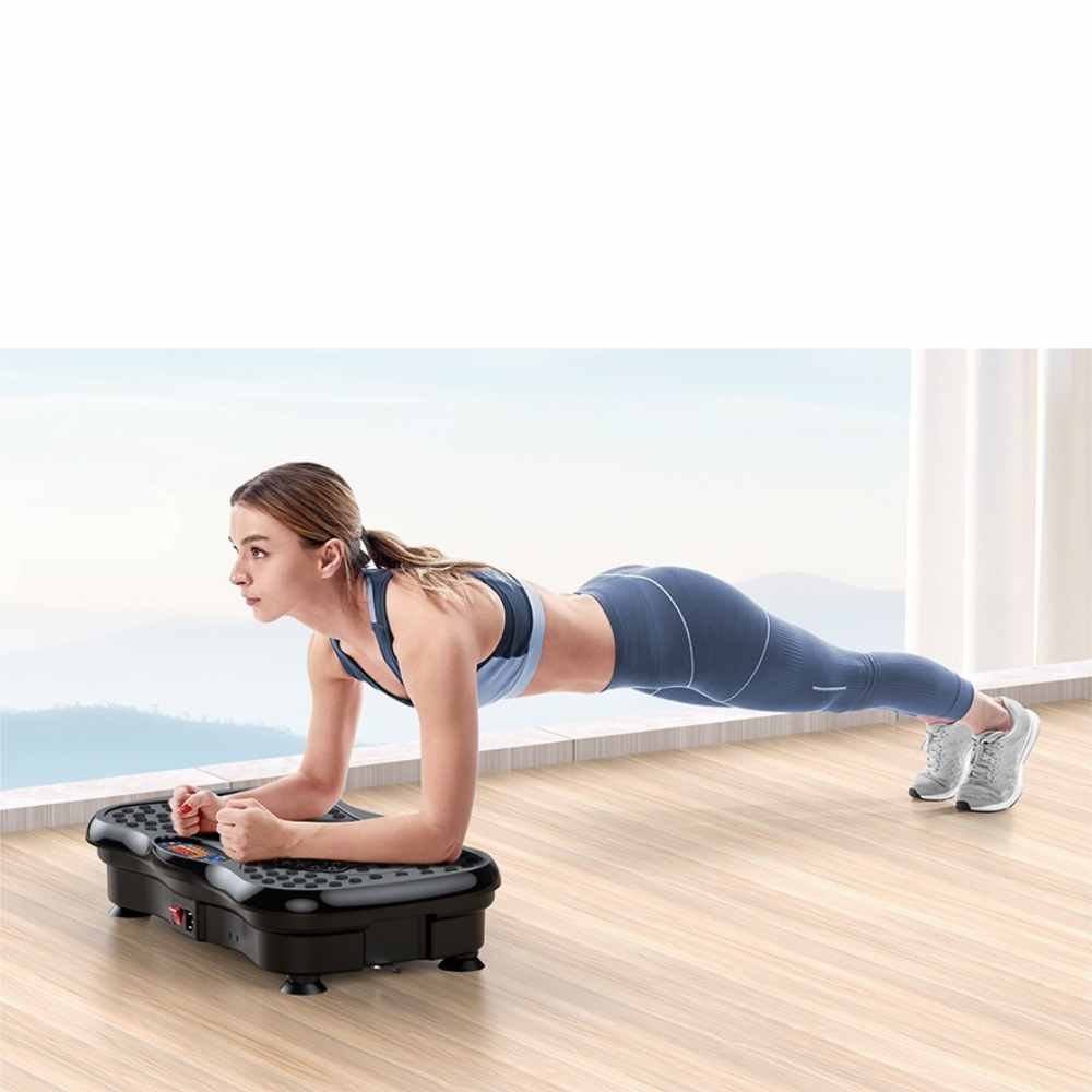 woman performing a plank exercise on a vibration plate machine