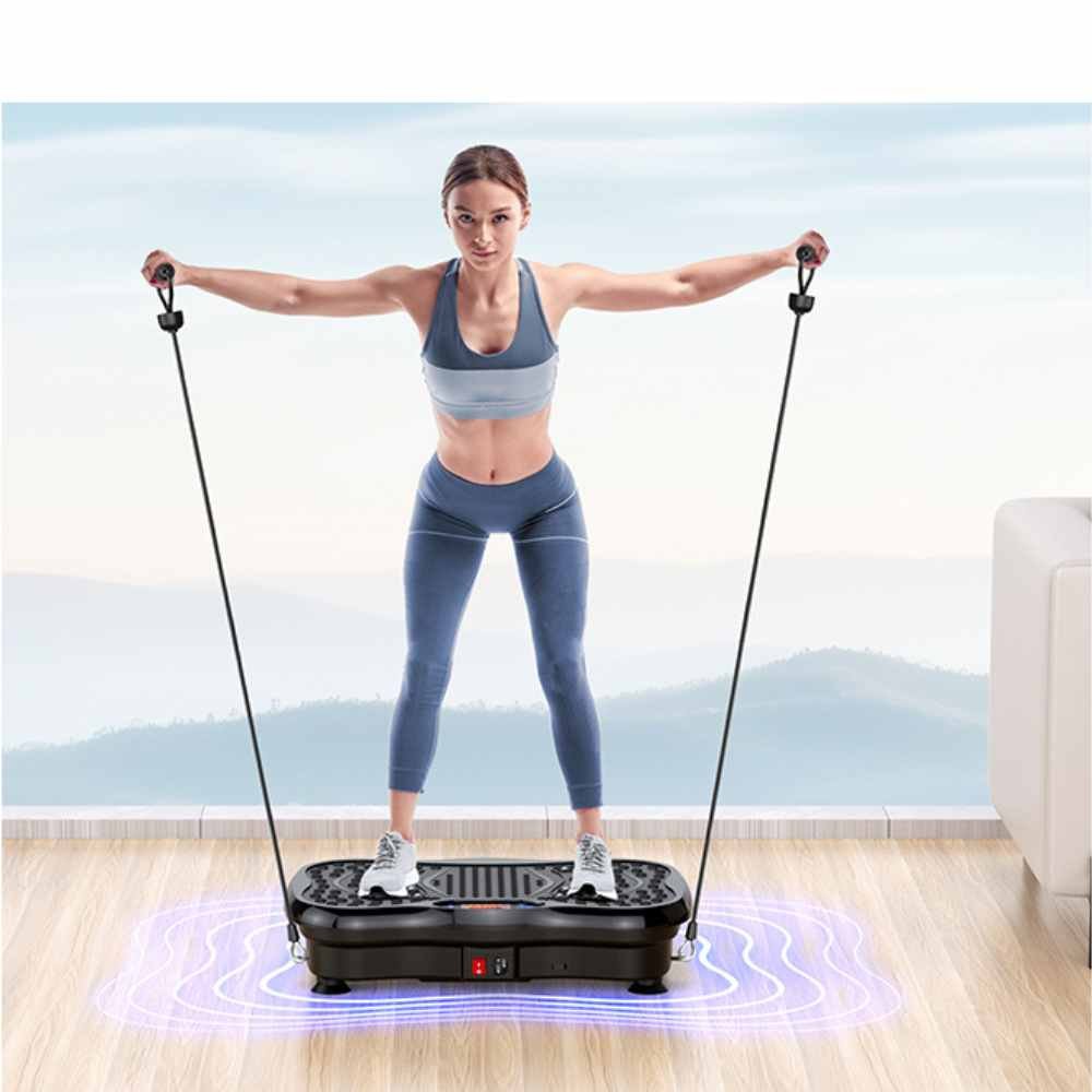 woman performing a resistance band workout while standing on a vibration plate machine