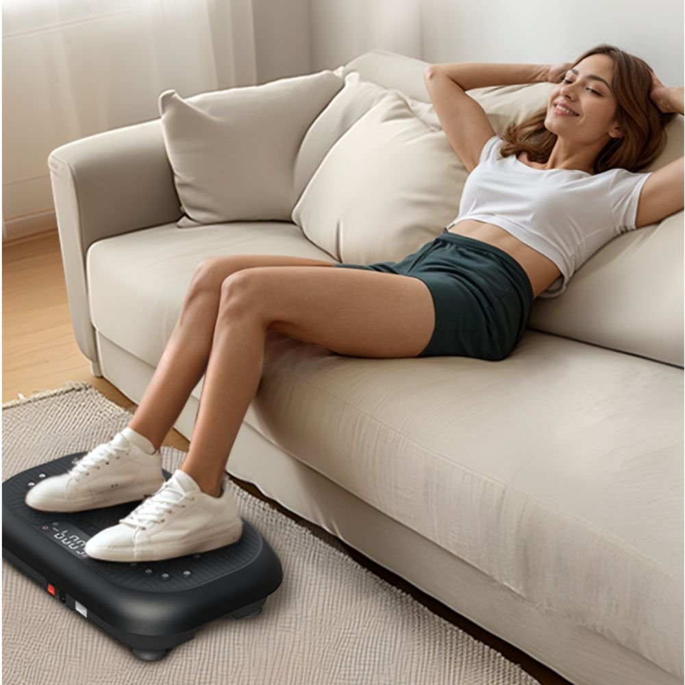 woman relaxing on a sofa with her feet placed on a vibration plate for foot massage